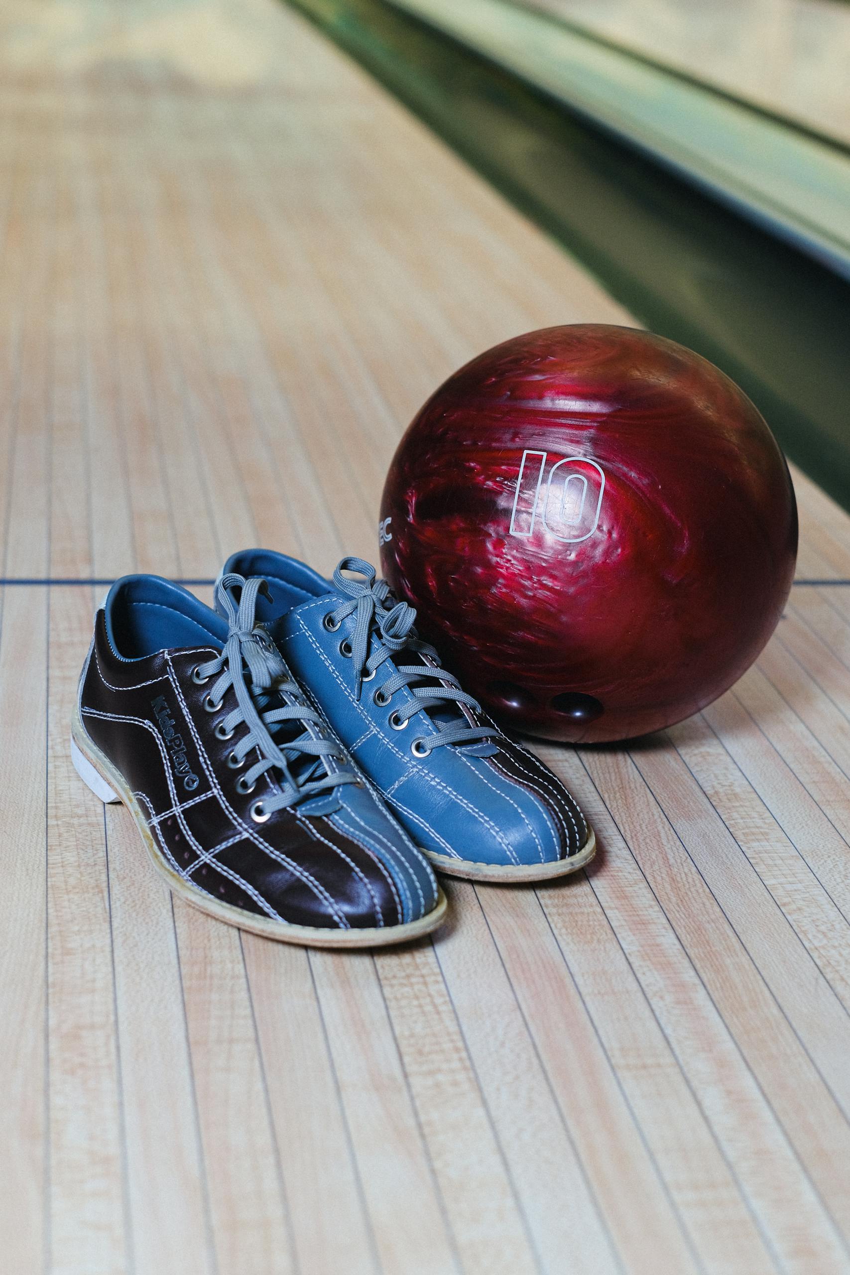 Bowling Shoes and Ball on Wooden Floor